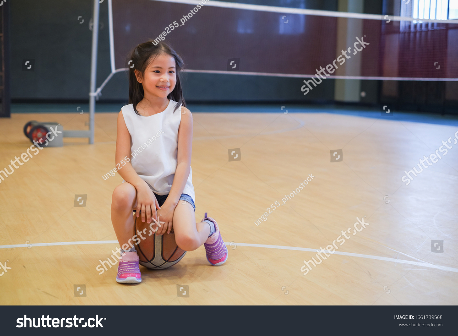 Portrait cute asian little child girl playing basketball