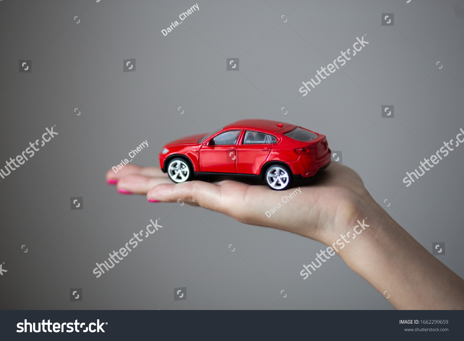 Closeup photo of woman hand holds a little car toy