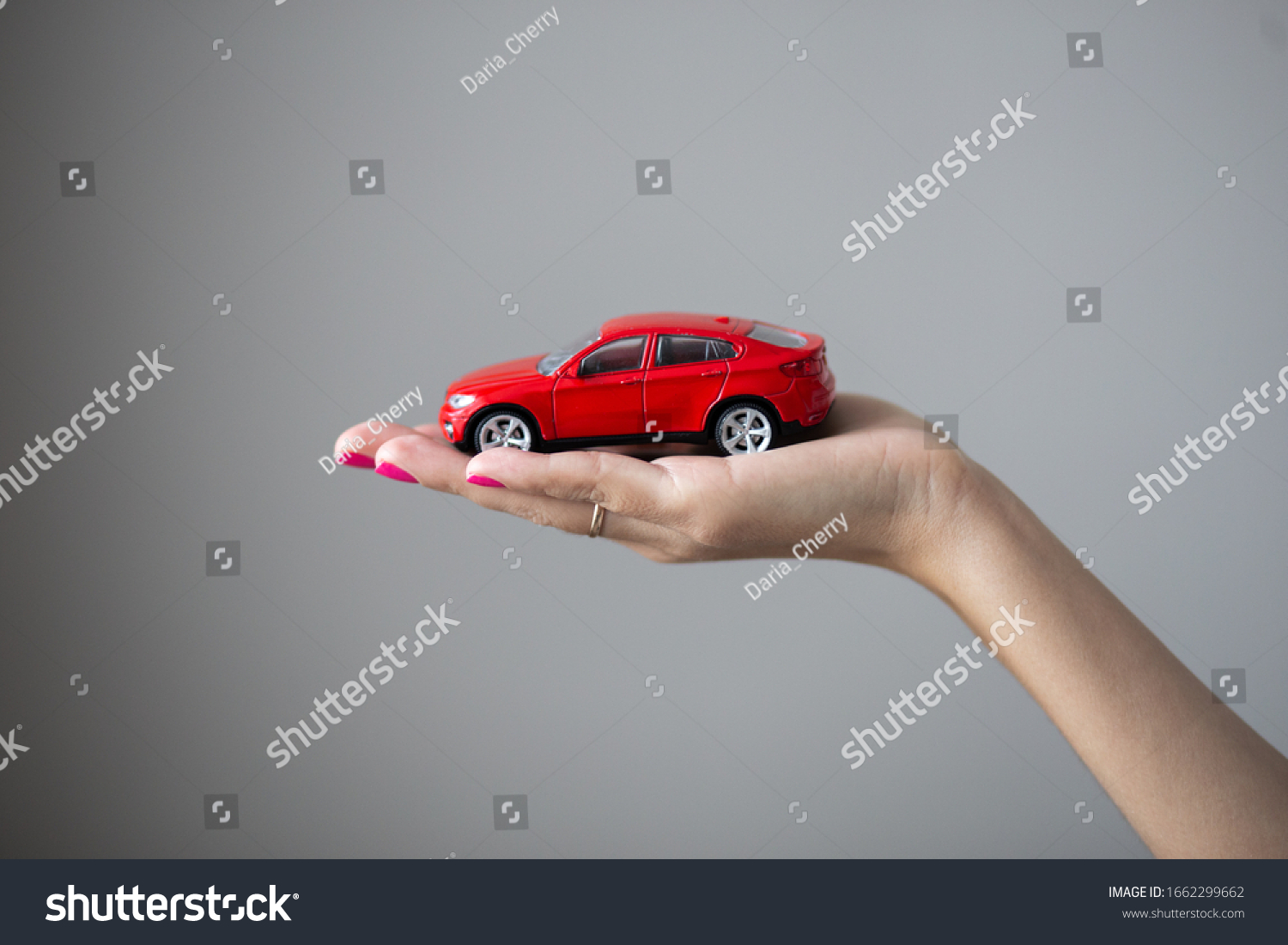Closeup photo of woman hand holds a little car toy