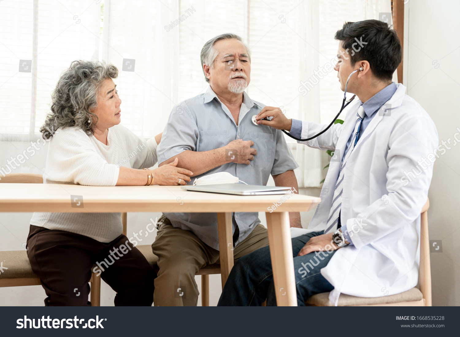 Asian elderly couples are sick doctor to check their symptoms at home. Health care life style pharmacy medical elder insurance after retire concept.