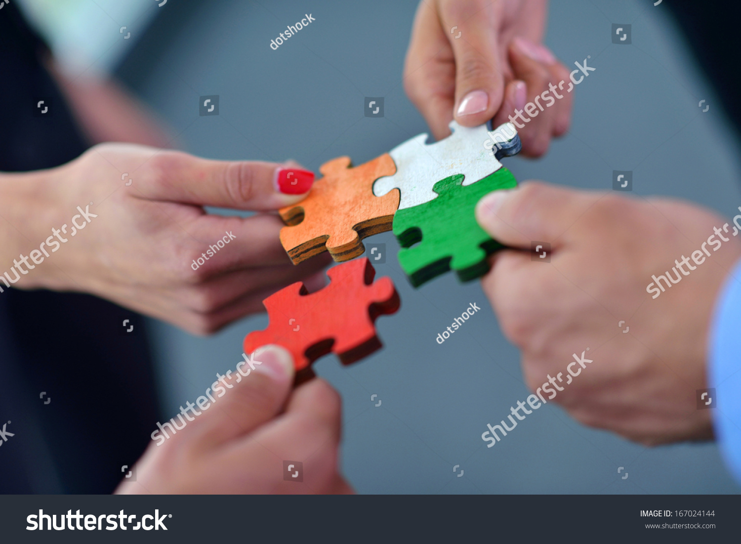 Group of business people assembling jigsaw puzzle and represent team support and help concept