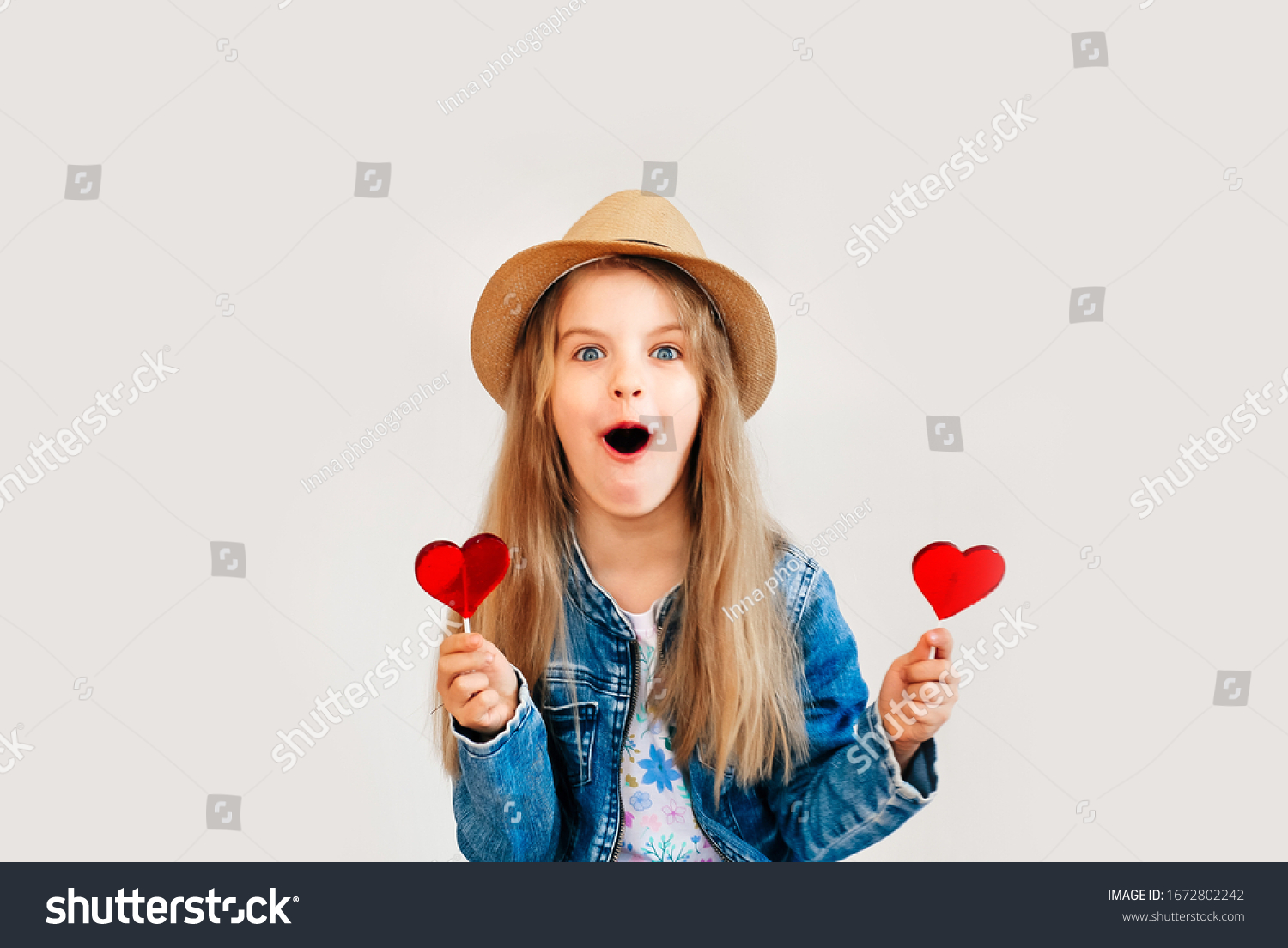 Portrait of a beautiful stylish fashionable girl in glasses with a heart-shaped lollipop on a white background free time summer vacation. Close up selective focus