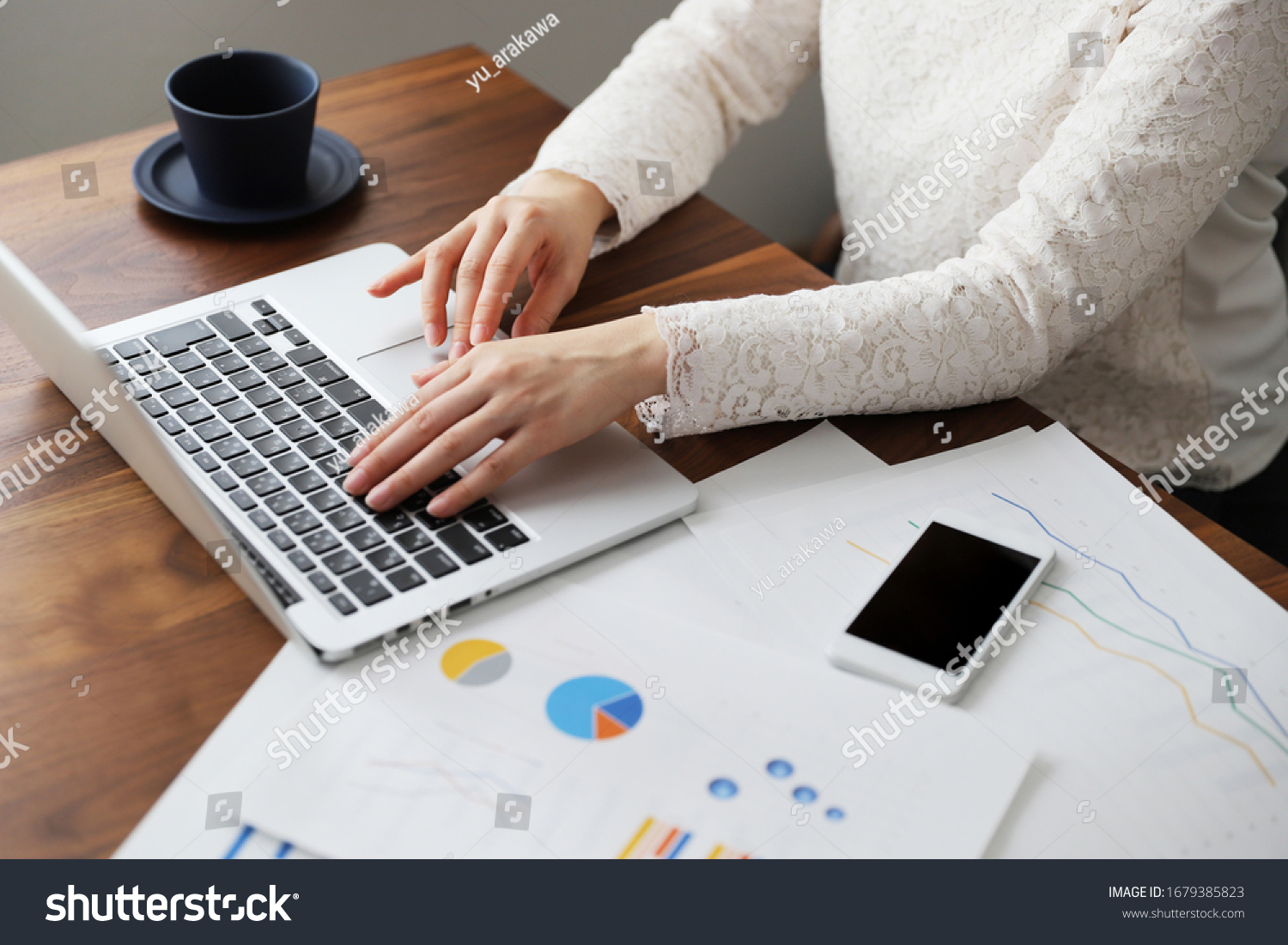A woman in a suit doing telework at home