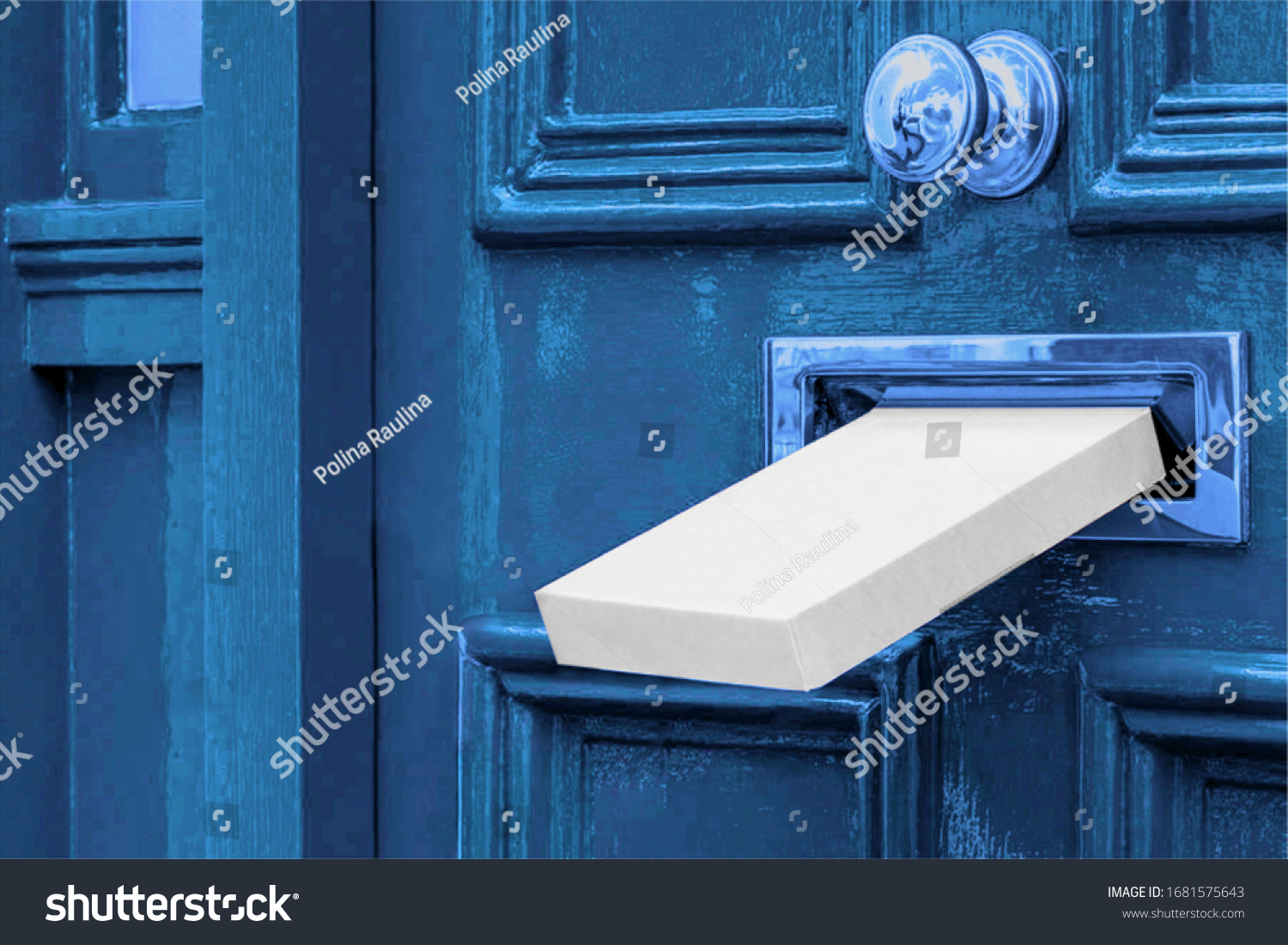 Sending a Gift In The Post.Postal white box the parcel is delivered through the parcel door opening.White post box and old aged grunge blue wooden door.
