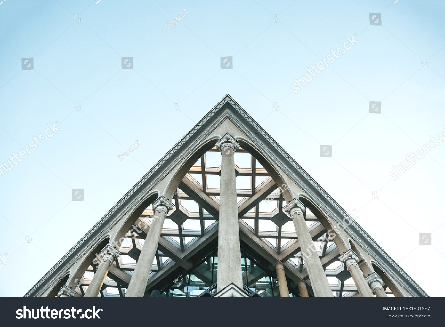 Close up of a symmetrical or symmetry point of view on the corner of a building with columns.