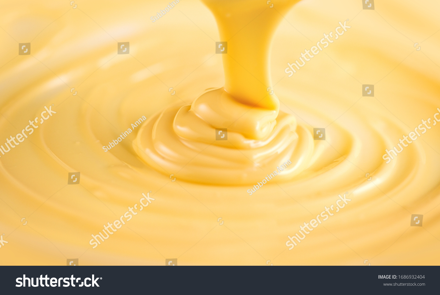 White Chocolate. Pouring melted liquid premium milk white chocolate