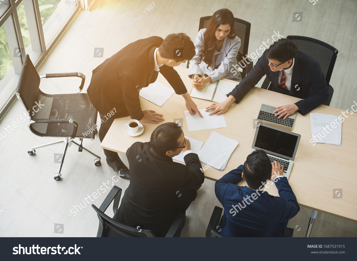 Top view of  asian business people team analyzing statistics financial. High angle view of a team of businesspeople Meeting Conference Discussion Corporate Concept in office.