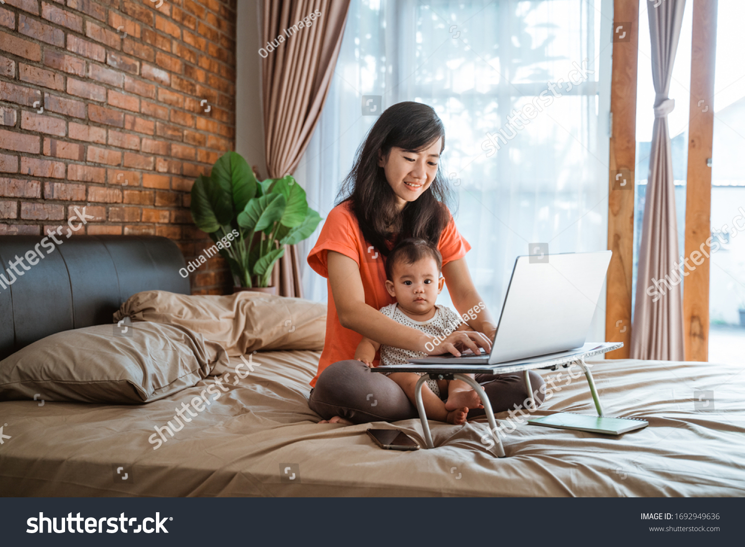 busy businesswoman working while taking care of her children at home