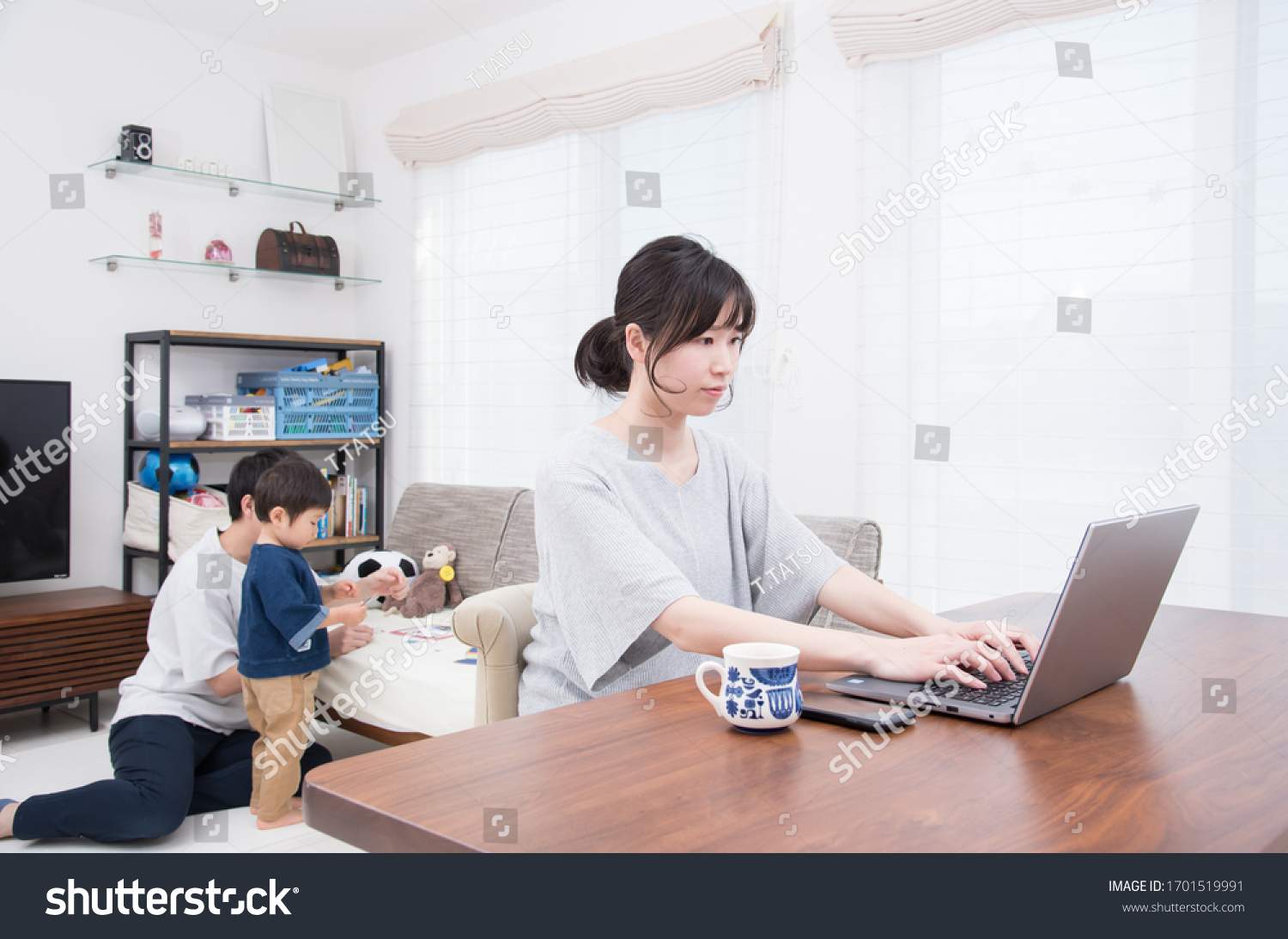 Mother working in home living room