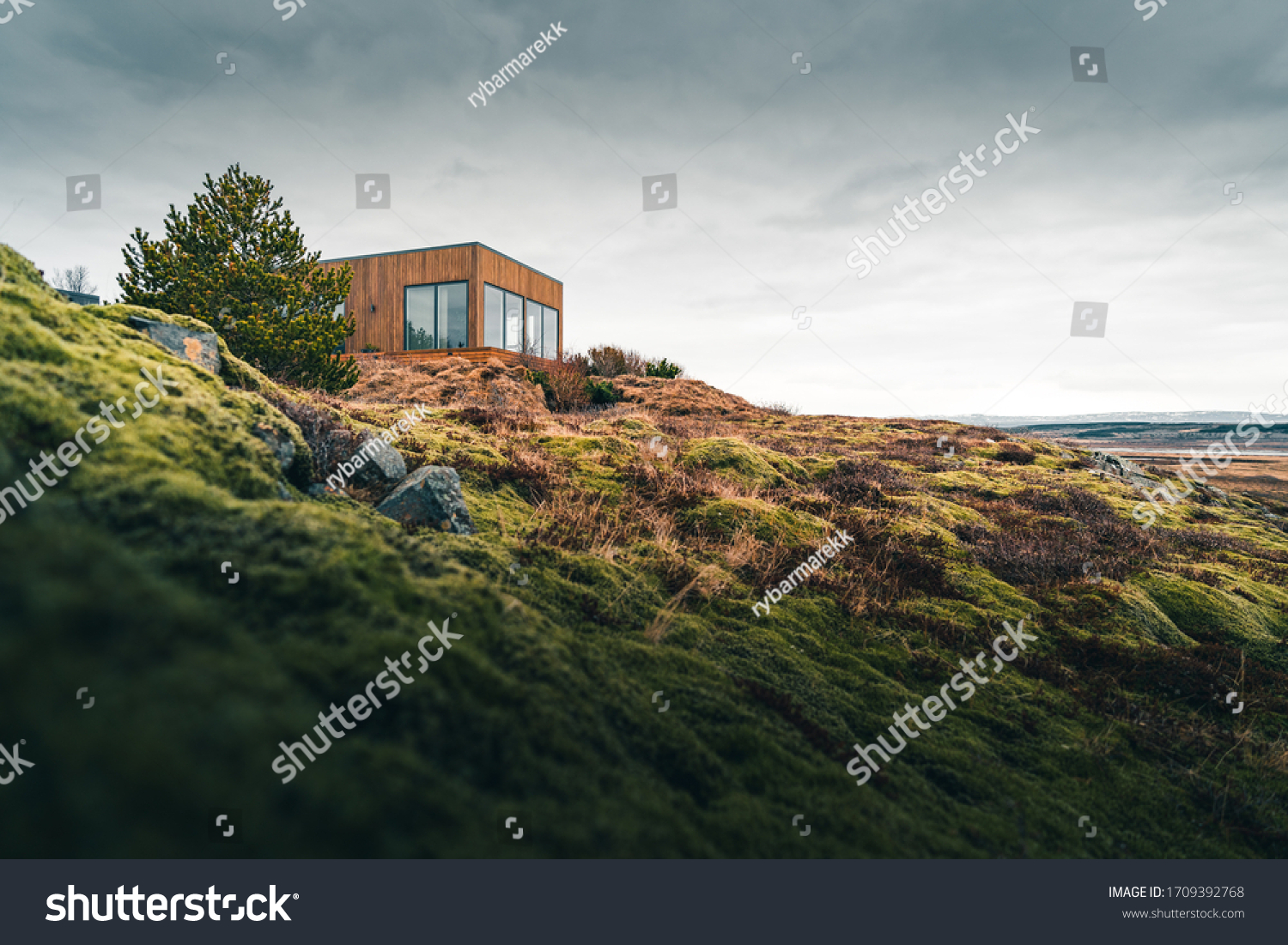 A tiny house on a grassy hill perfect for isolated vacation or just a peaceful relax in the connection with nature. Modern architecture in the Scandinavian countries