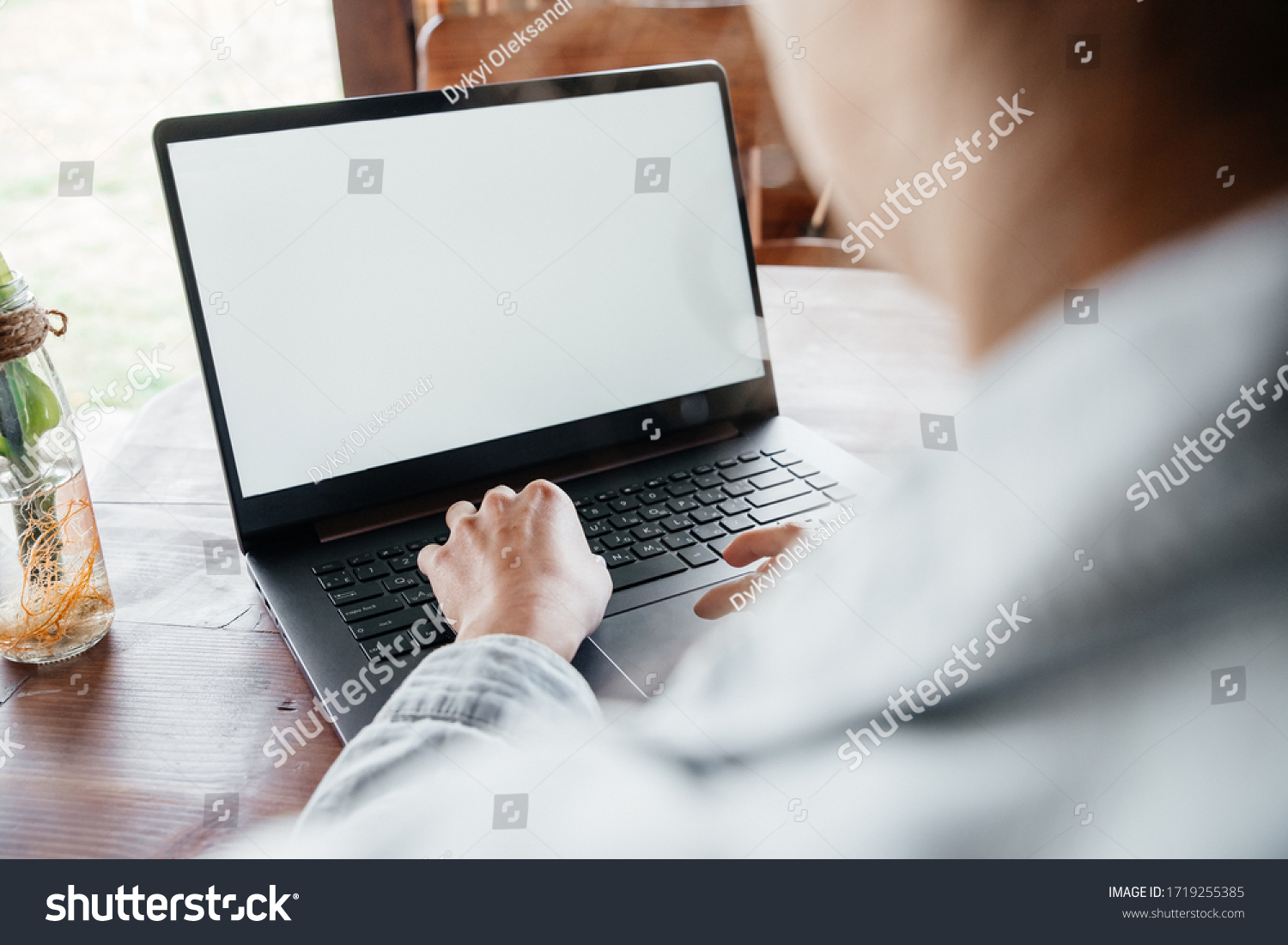young woman working freelance at computer at home on terrace