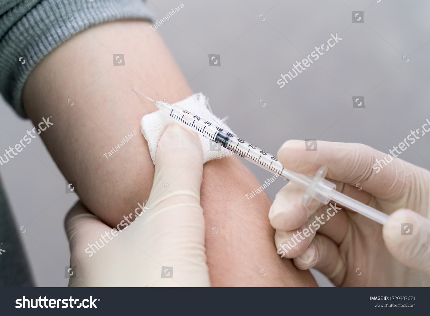 nurse holding a syringe with a vaccine