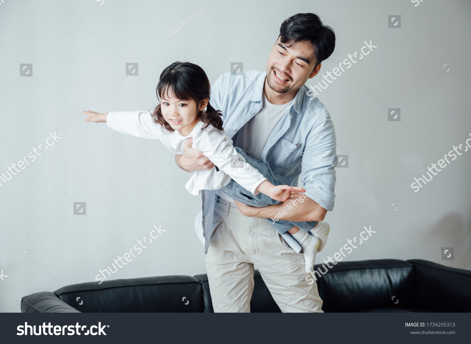 Father and daughter at home playing games