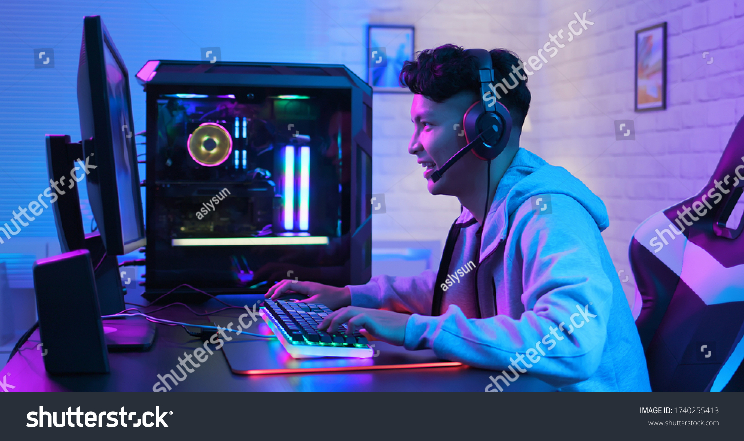 Young Asian Handsome Pro Gamer Feel Excited While playing in Online Cyber Sport Game at home