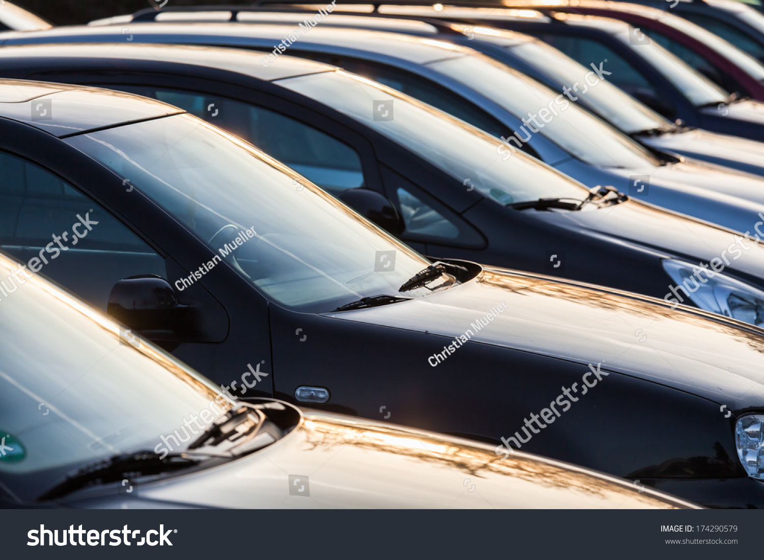 row of cars on a parking lot 