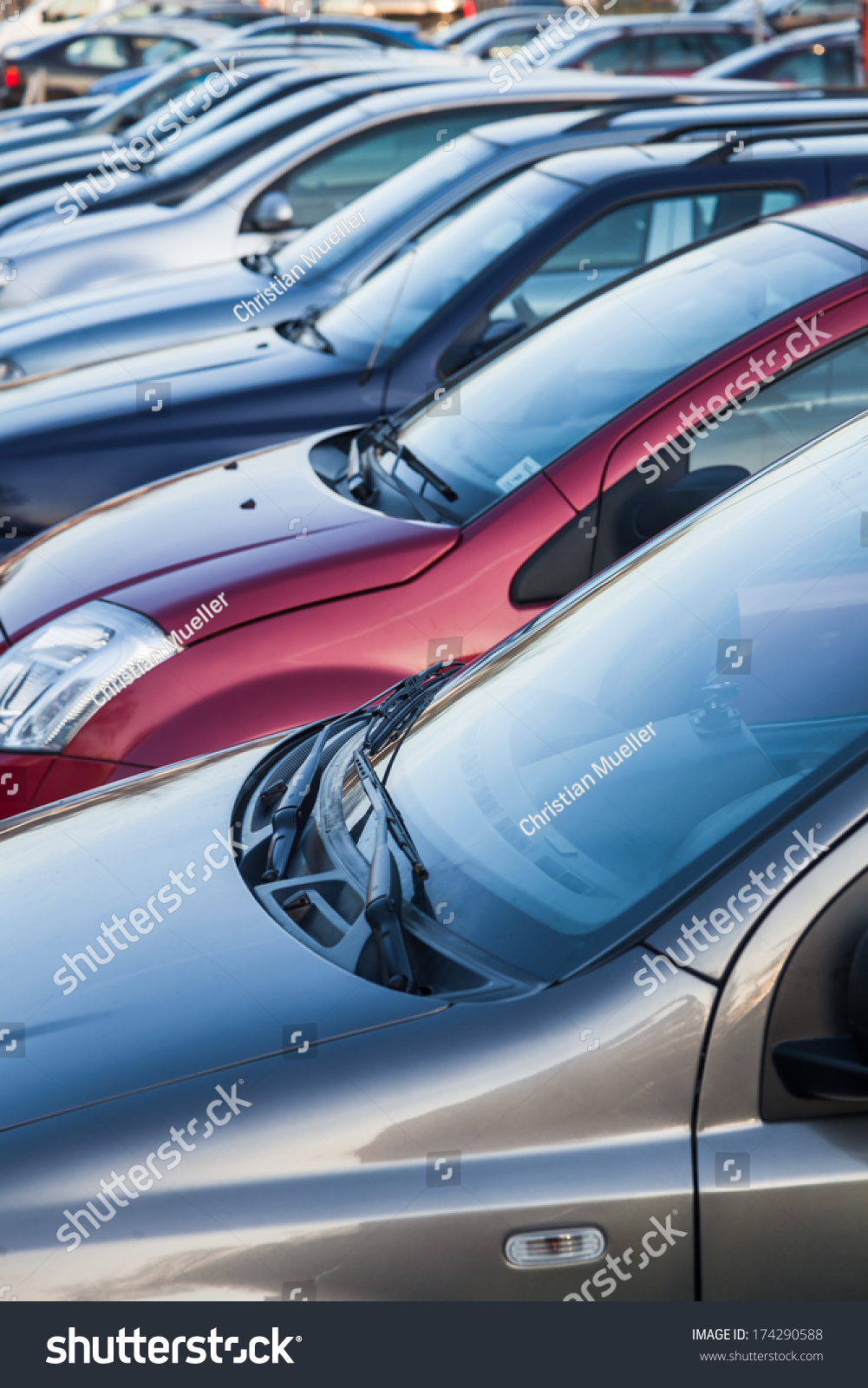 row of cars on a parking lot 