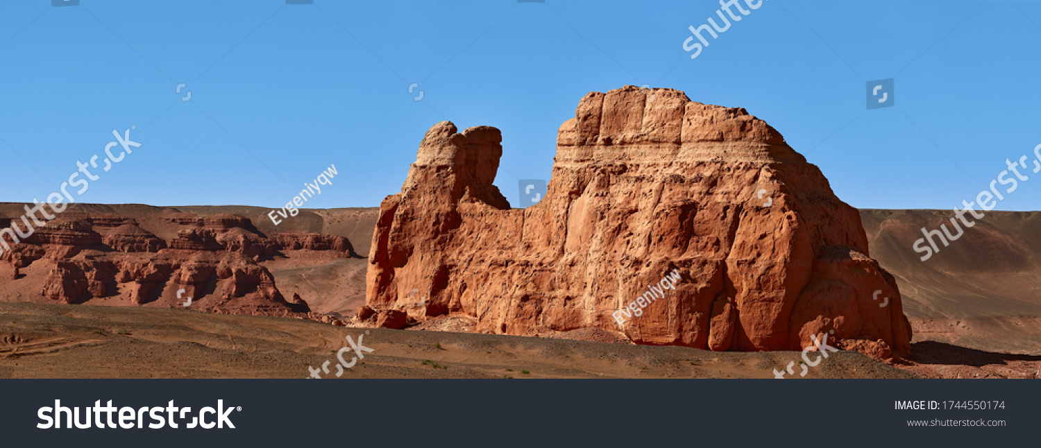 Herman Cav Canyon at sunset. South Gobi  Mongolia. Herman Tsav Canyon. Red Sandstone plateau  Martian landscape. The site of many paleontological finds. Cemetery of dinosaurs.