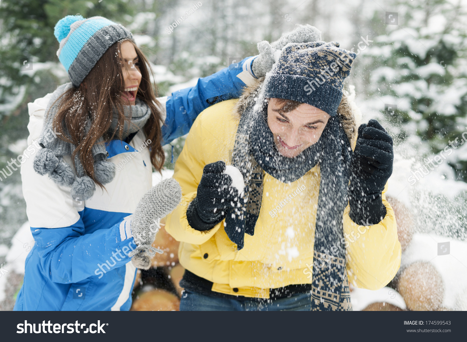 Young couple have fun during the snowball fight