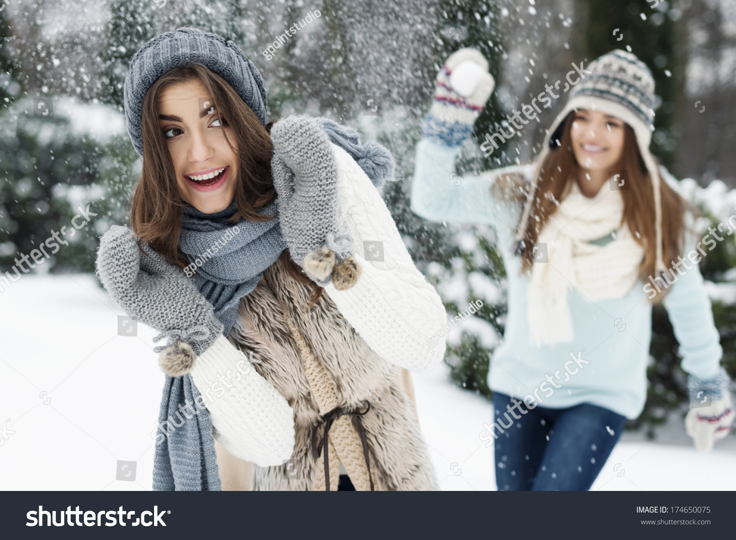 Young women have fun during the snowball fight