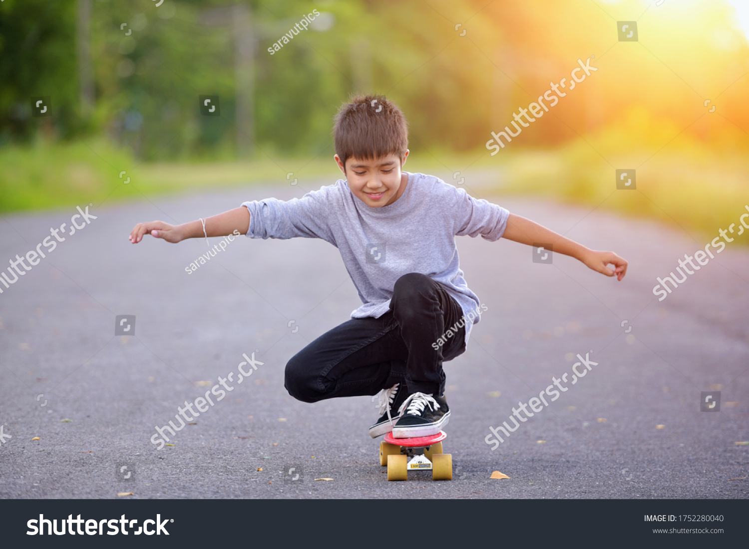 Boy learn to skate on skateboard.Child and Skateboarding In Park