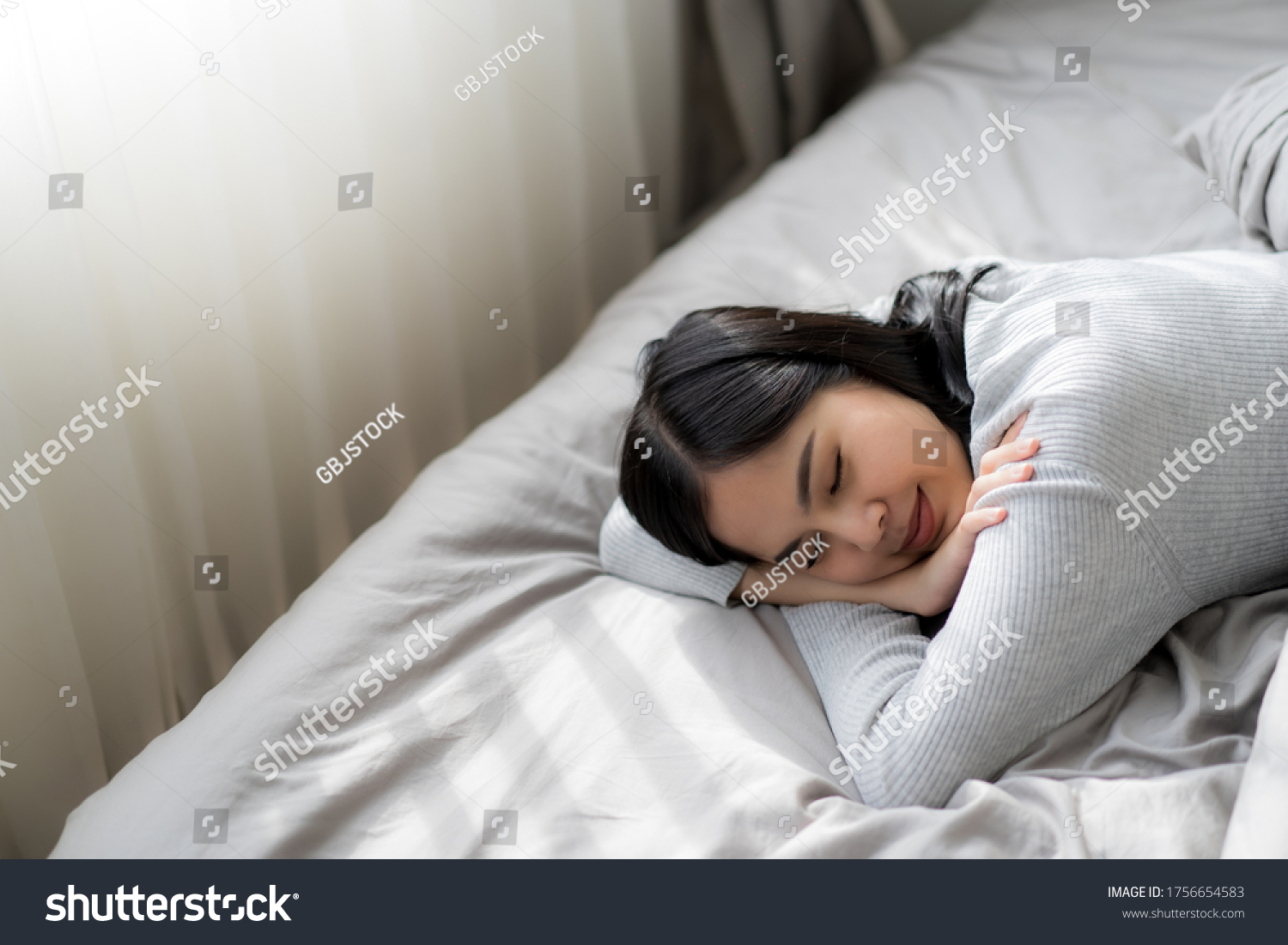 Young beautiful woman sleeping or take a nap in bed