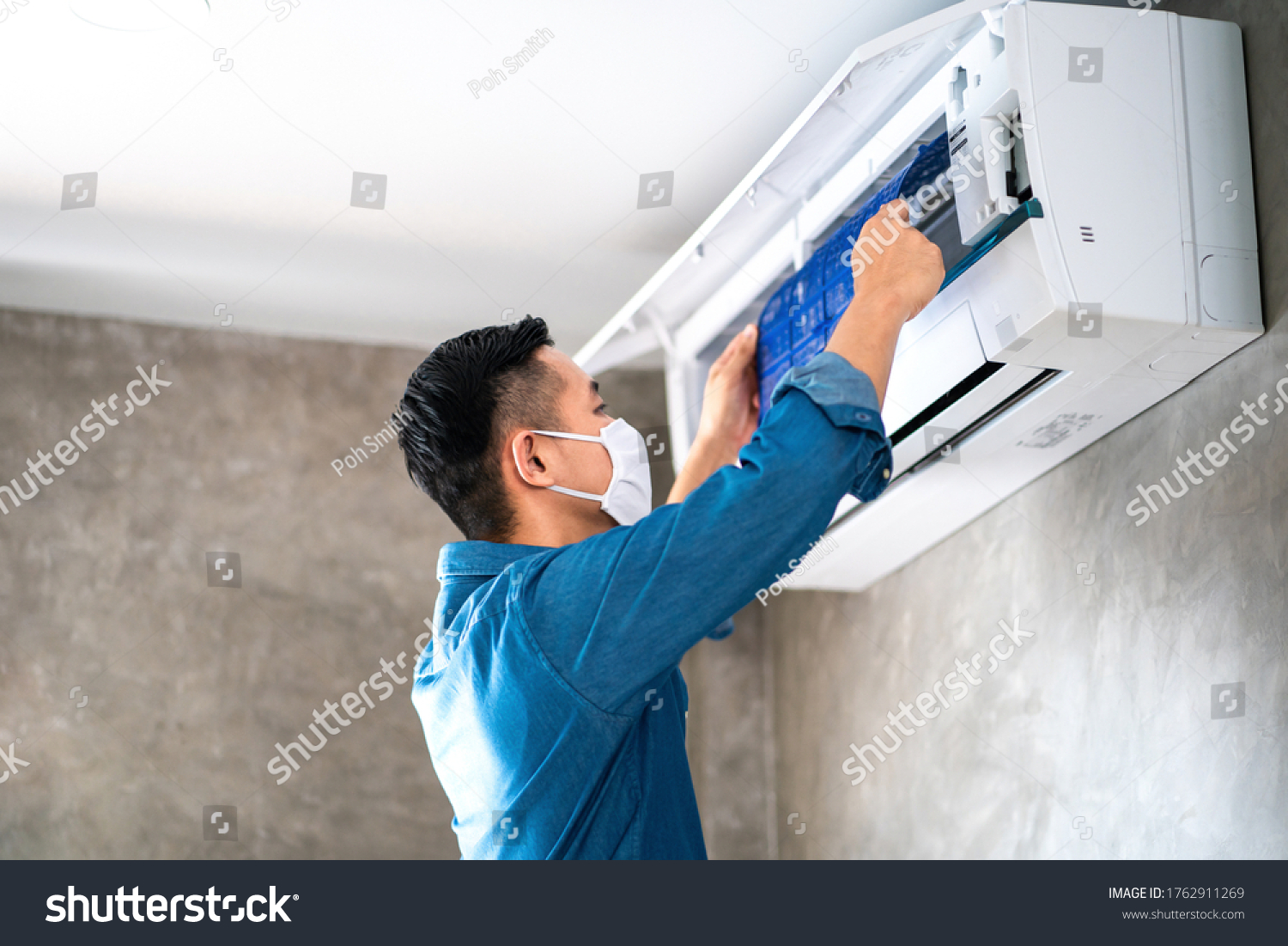 Technician man repairing cleaning and maintenance Air conditioner on the wall in bedroom or office room.On site home service Business Industrial concept.
