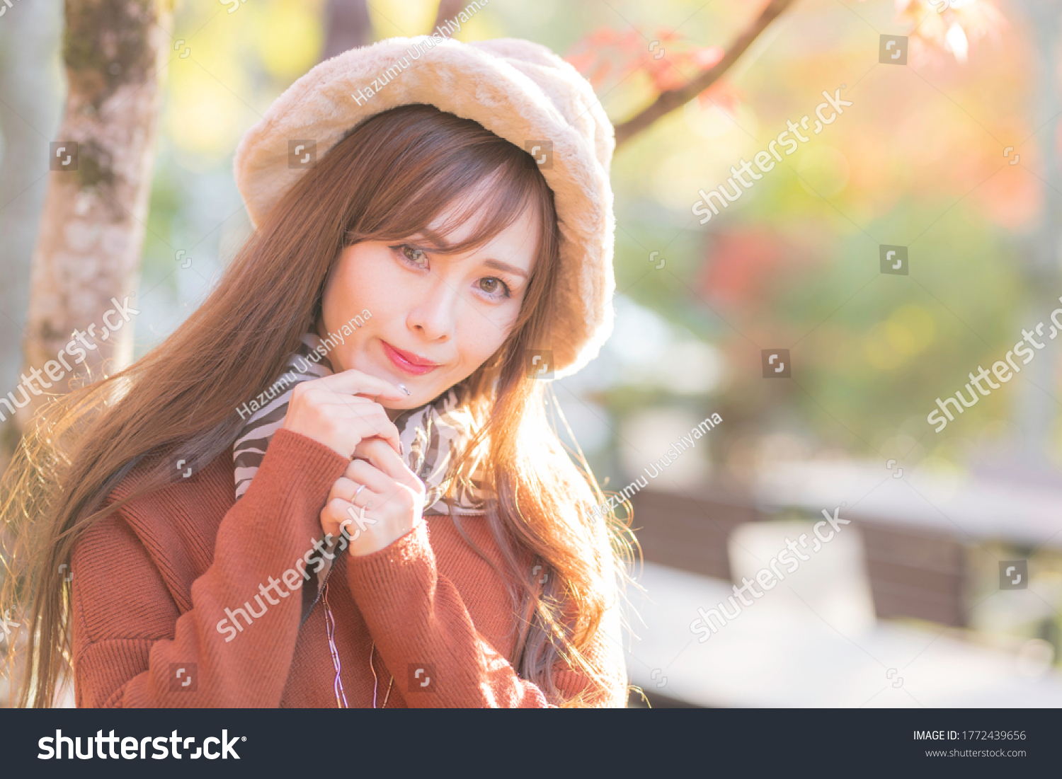 
A young woman reflected in the background of autumn leaves