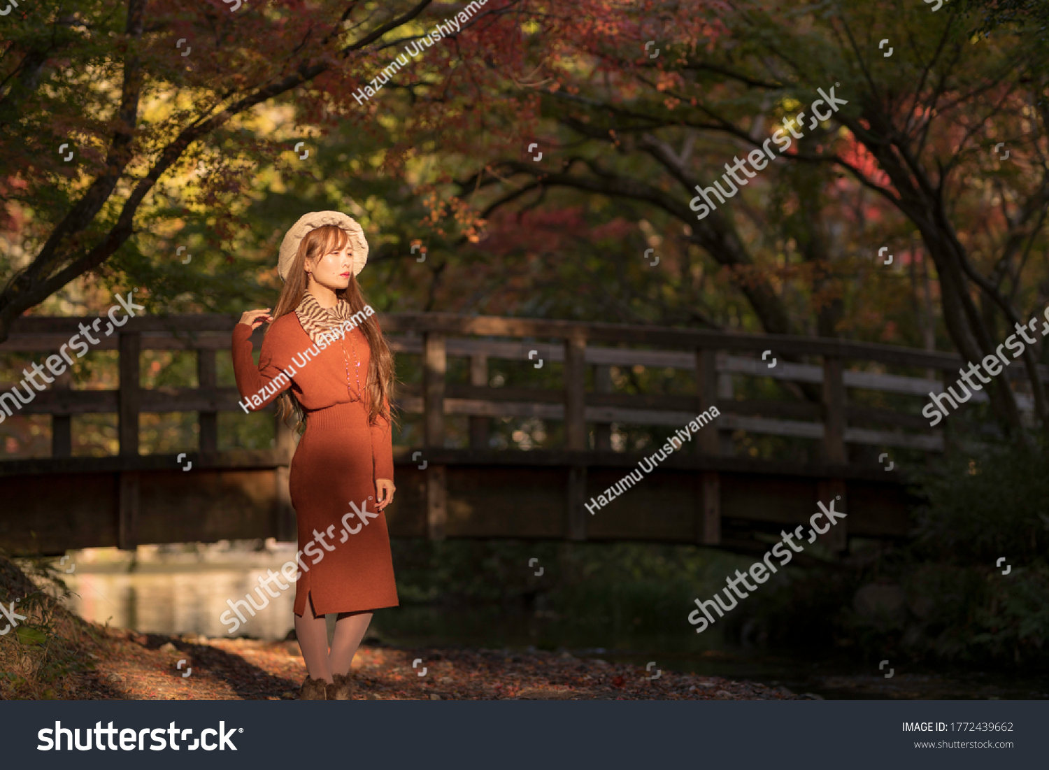
A young woman reflected in the background of autumn leaves