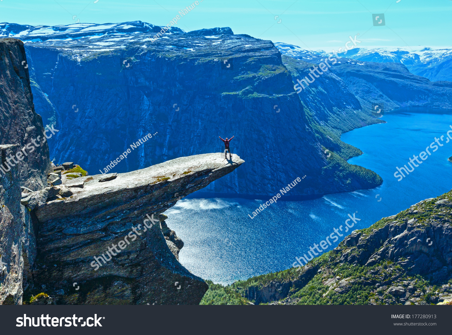 Man tourist on summer Trolltunga (The Troll's tongue) in Odda ( Ringedalsvatnet lake  Norway). Beautiful natural vacation hiking walking travel to nature destinations concept.