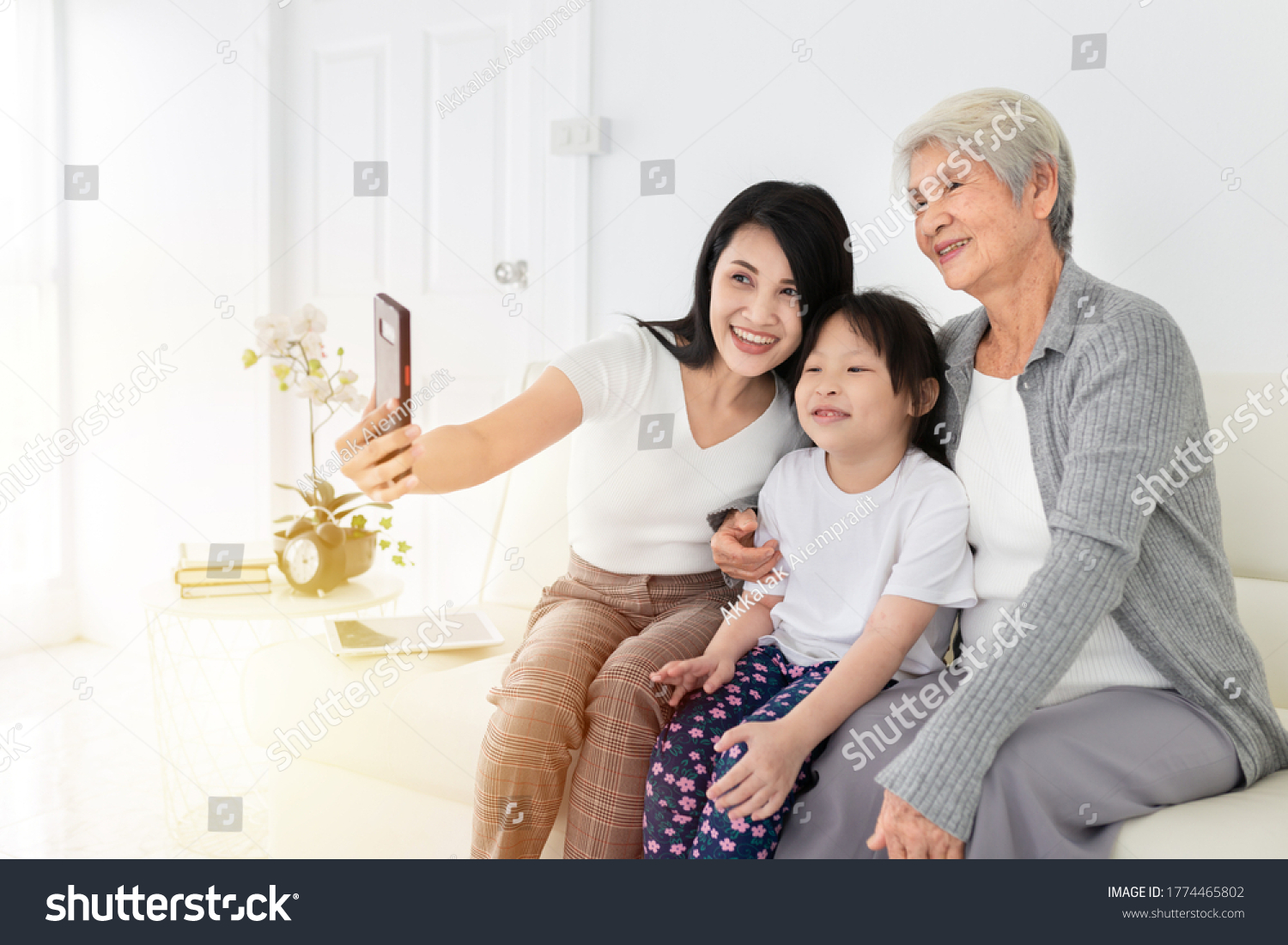 close up old female Asian female use smartphone take photo with old female and children they feeling happy and smile mother's day and happiness family time technology and social network