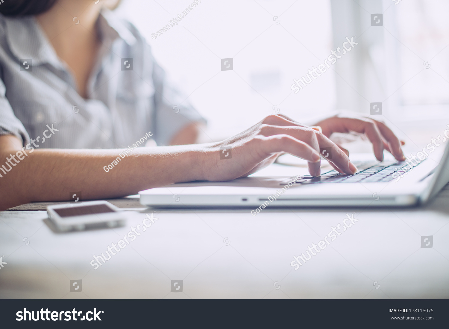 Closeup of a female hands busy typing on a laptop