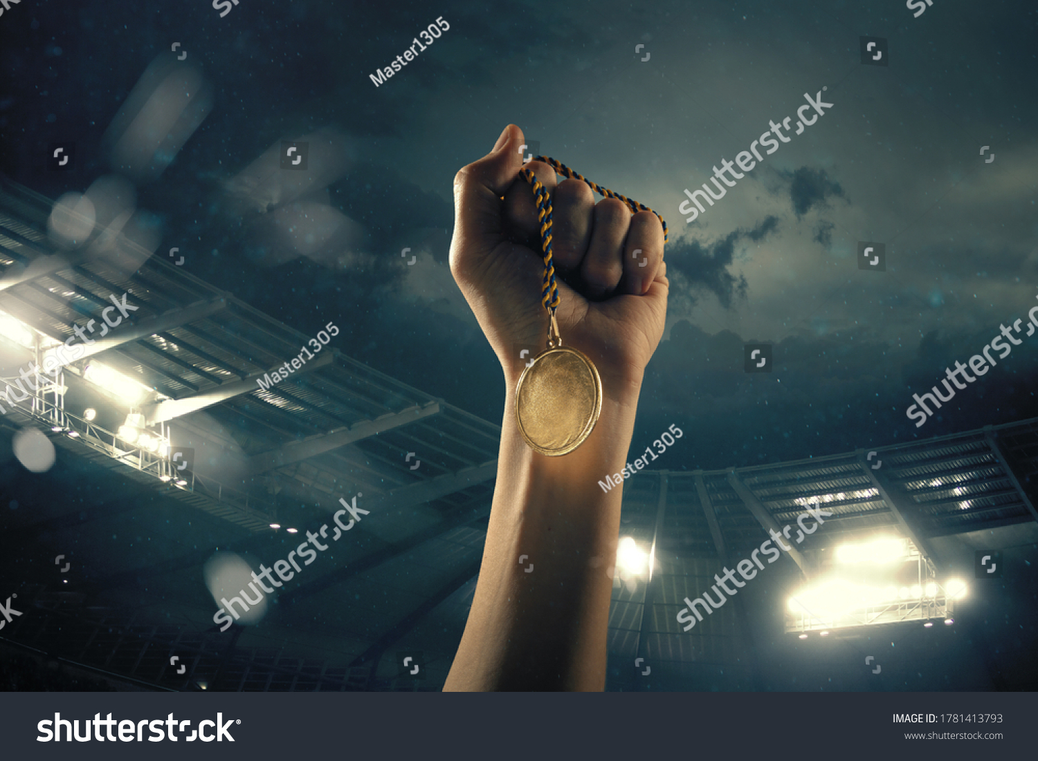 Champion. Award of victory  male hands tightening the golden medal of winners against cloudy dark sky. Sport  competition  championship  winning  achieving the goal. Prize for success and honor.