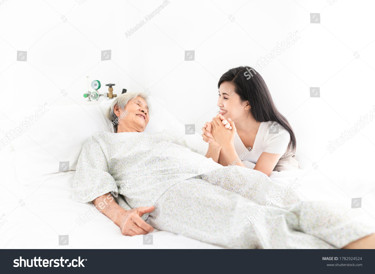old asian patient sick and admit in hospital young asian female visiting old female they holding hands together they feeling happy and smile elderly healthcare