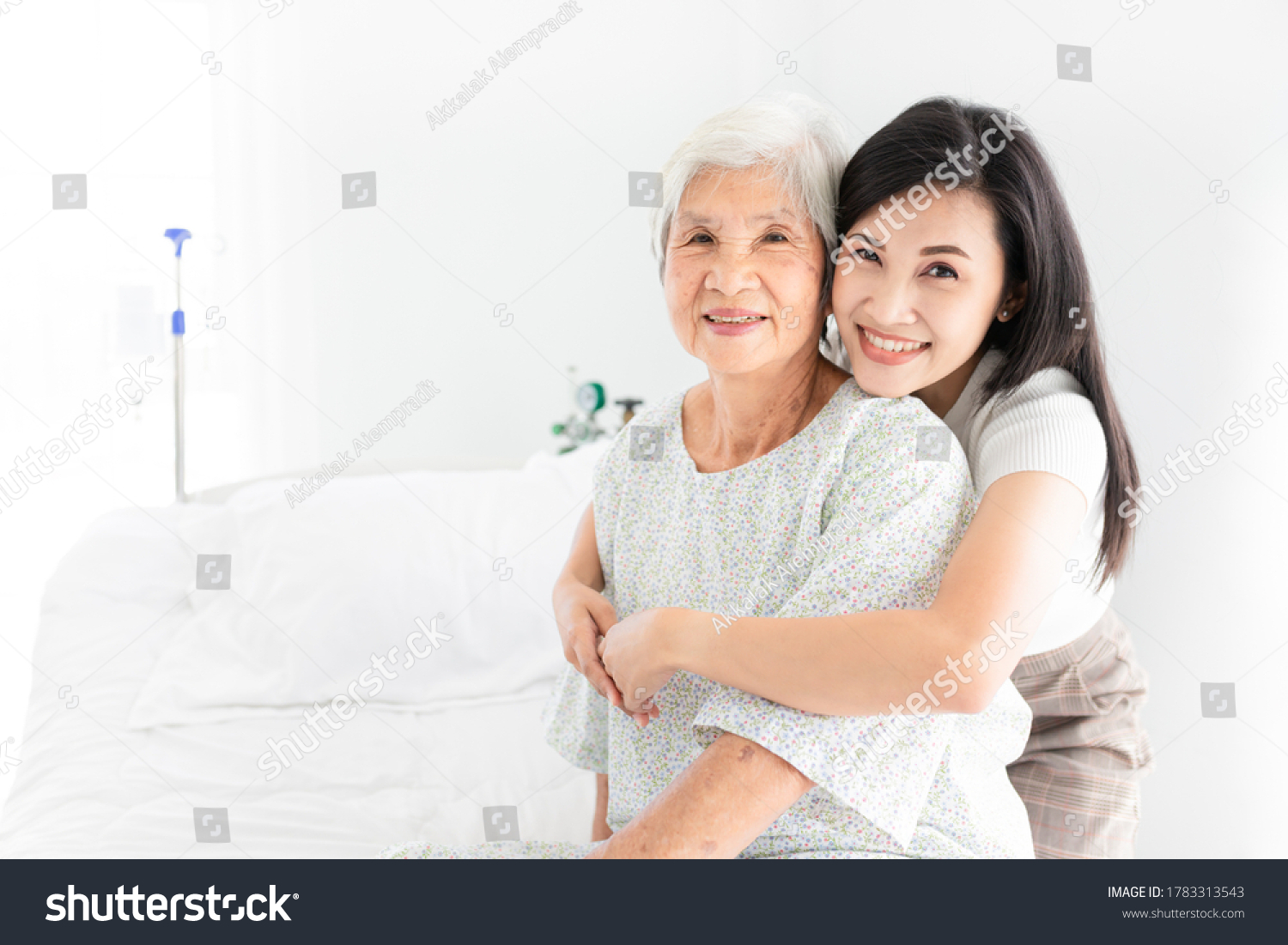 old asian patient sick and admit in hospital young asian female visiting old female she hug old female they feeling happy and smile elderly healthcare