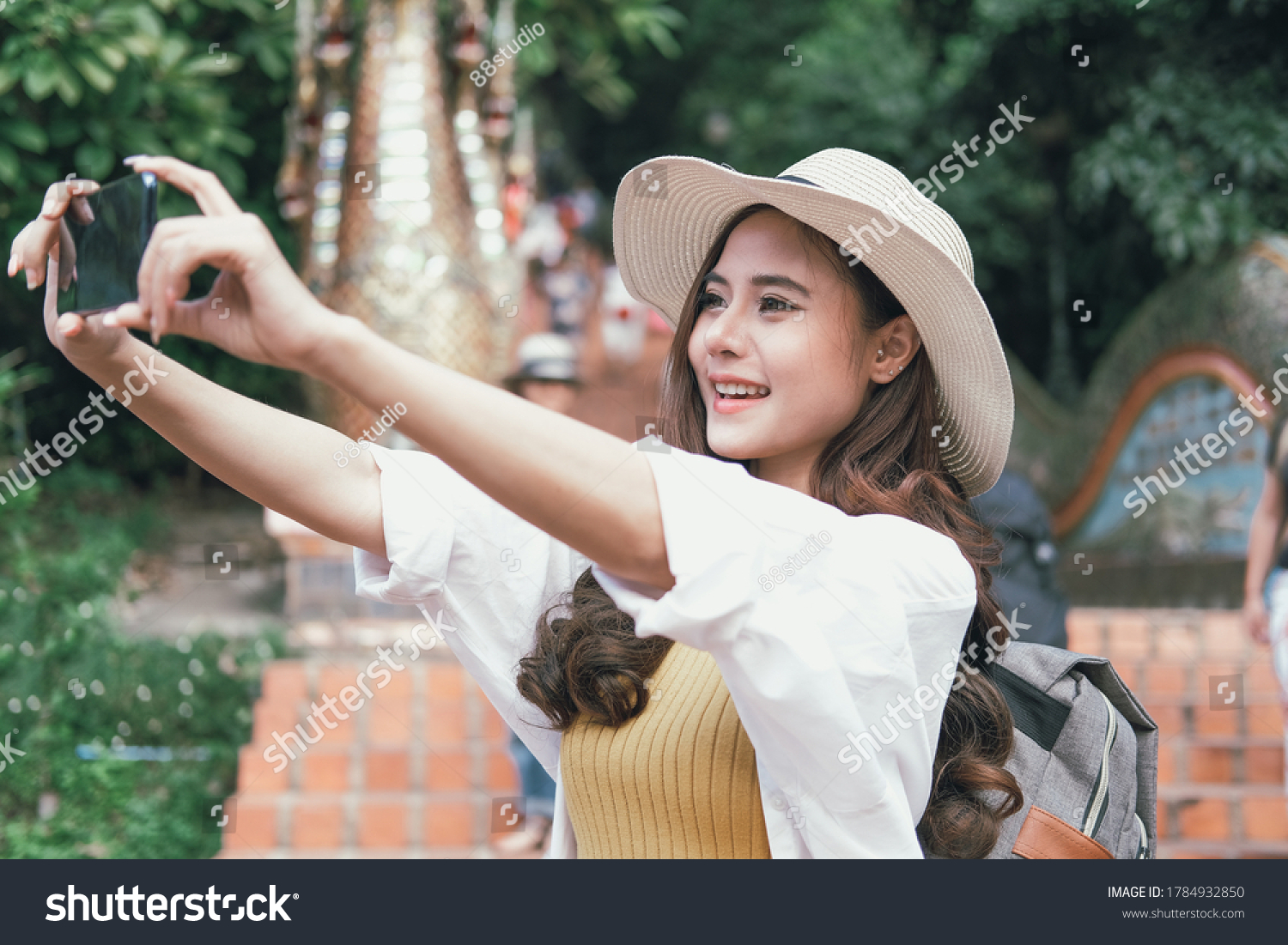 asian woman use smart phone to take selfie photo. traveler tourist travel on holiday vacation. journey trip concept