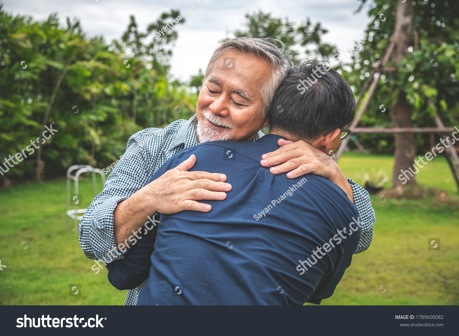 Father and son show love by hugging in outdoors  asian family