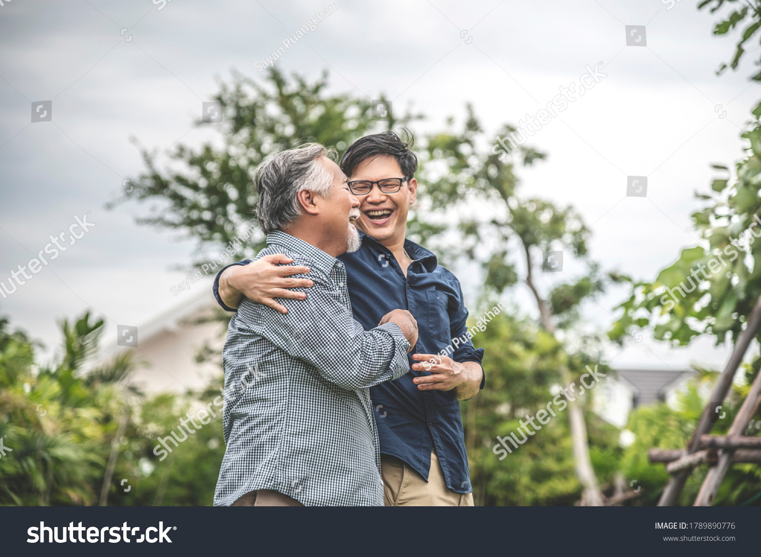 Father and son  embracing and talking happily  asian family