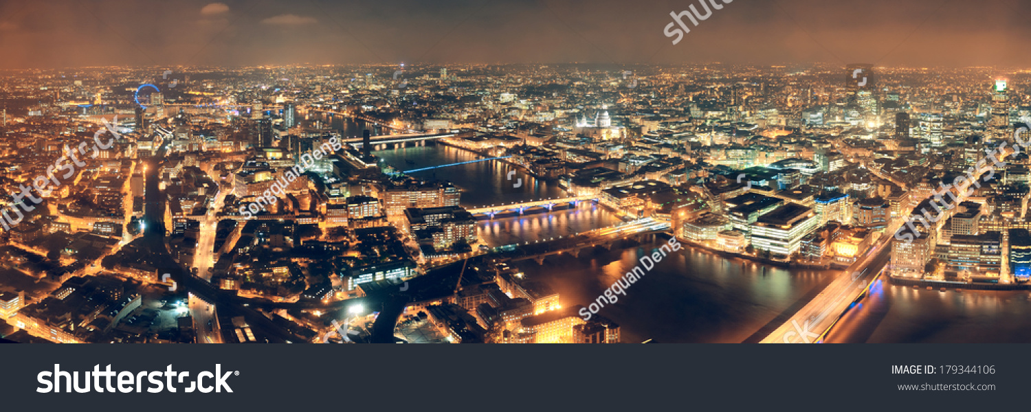 London aerial view panorama at night with urban architectures and bridges.