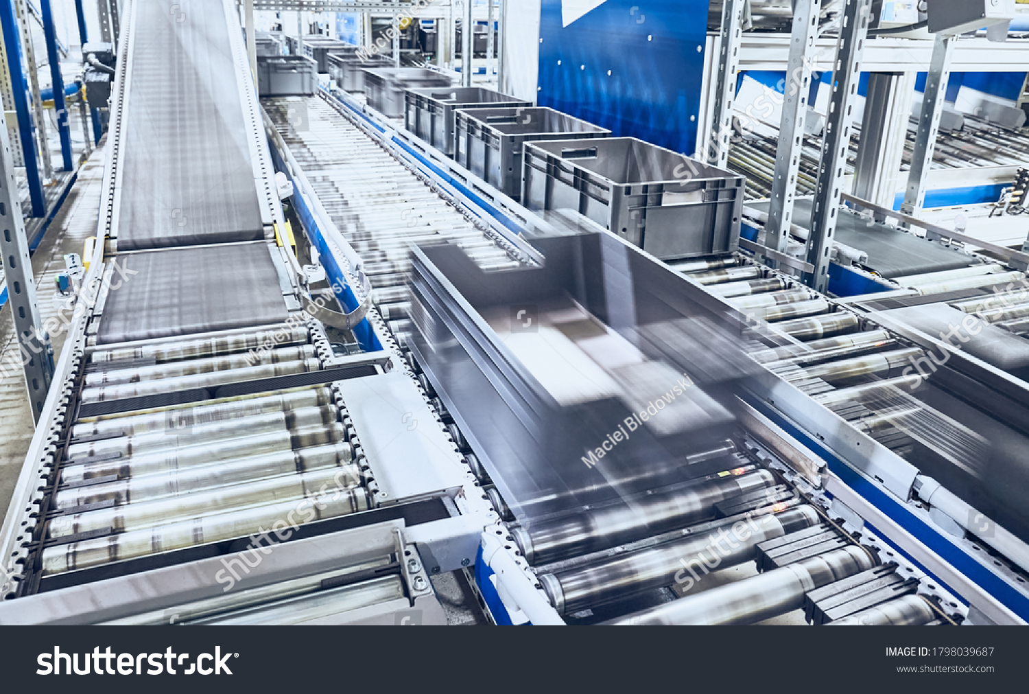 Modern roller conveyor system with boxes in motion  shallow depth of field.