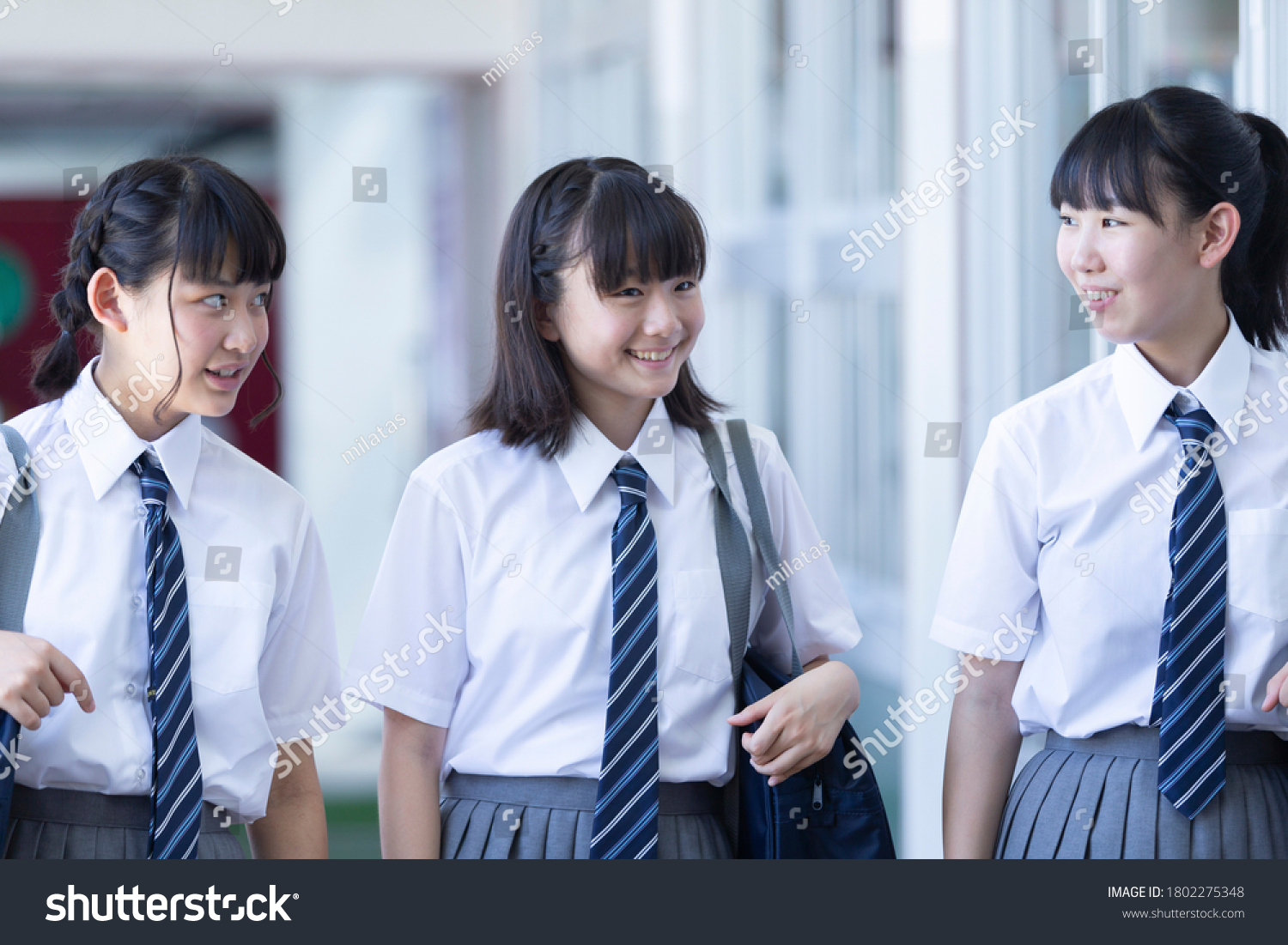 Junior high school students walking side by side in the corridor