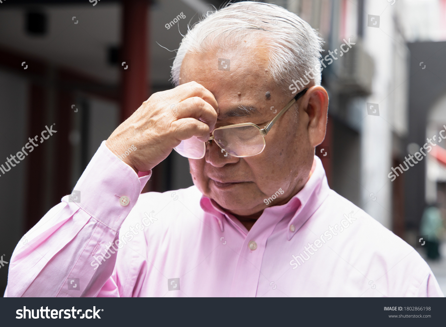 sick asian senior man suffering from sinusitis headache; health and sickness concept