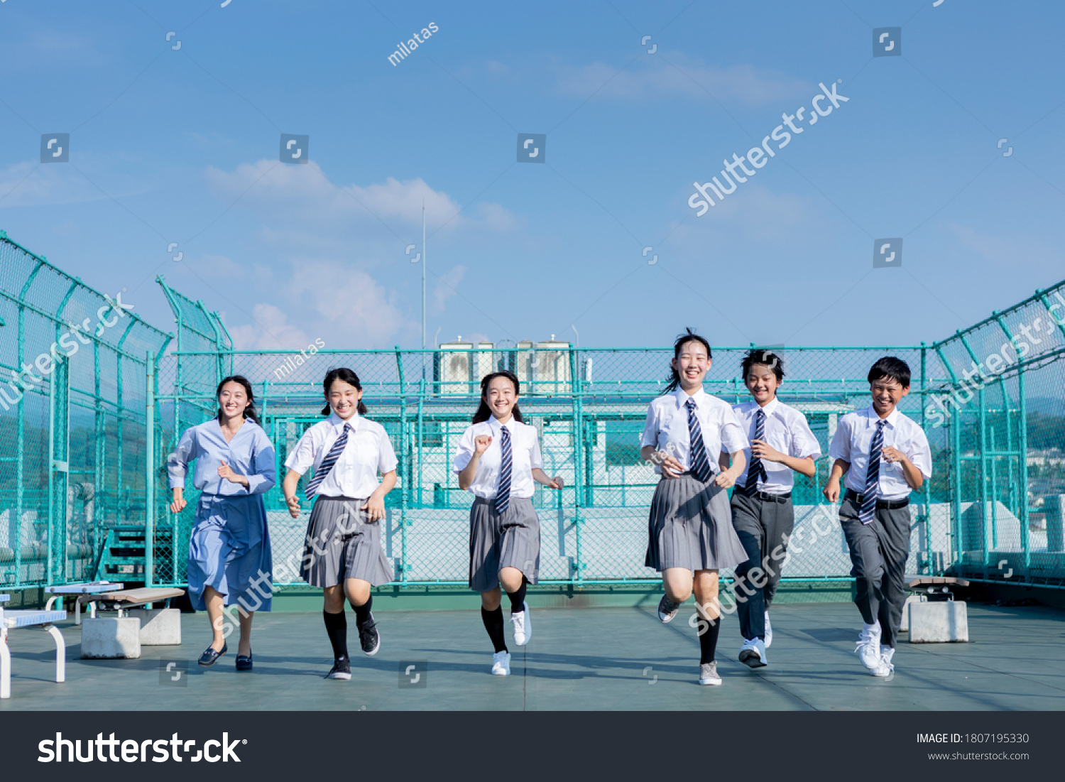 Junior high school students and teachers running on the rooftop