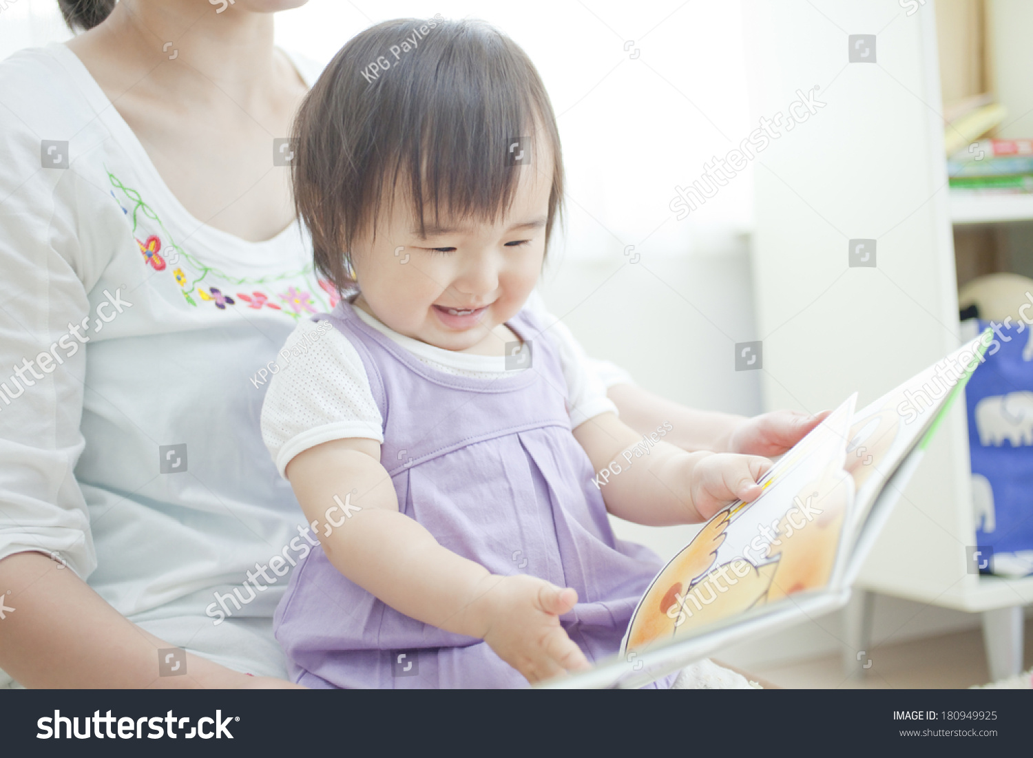 Japanese girl reading a picture book to her mother 