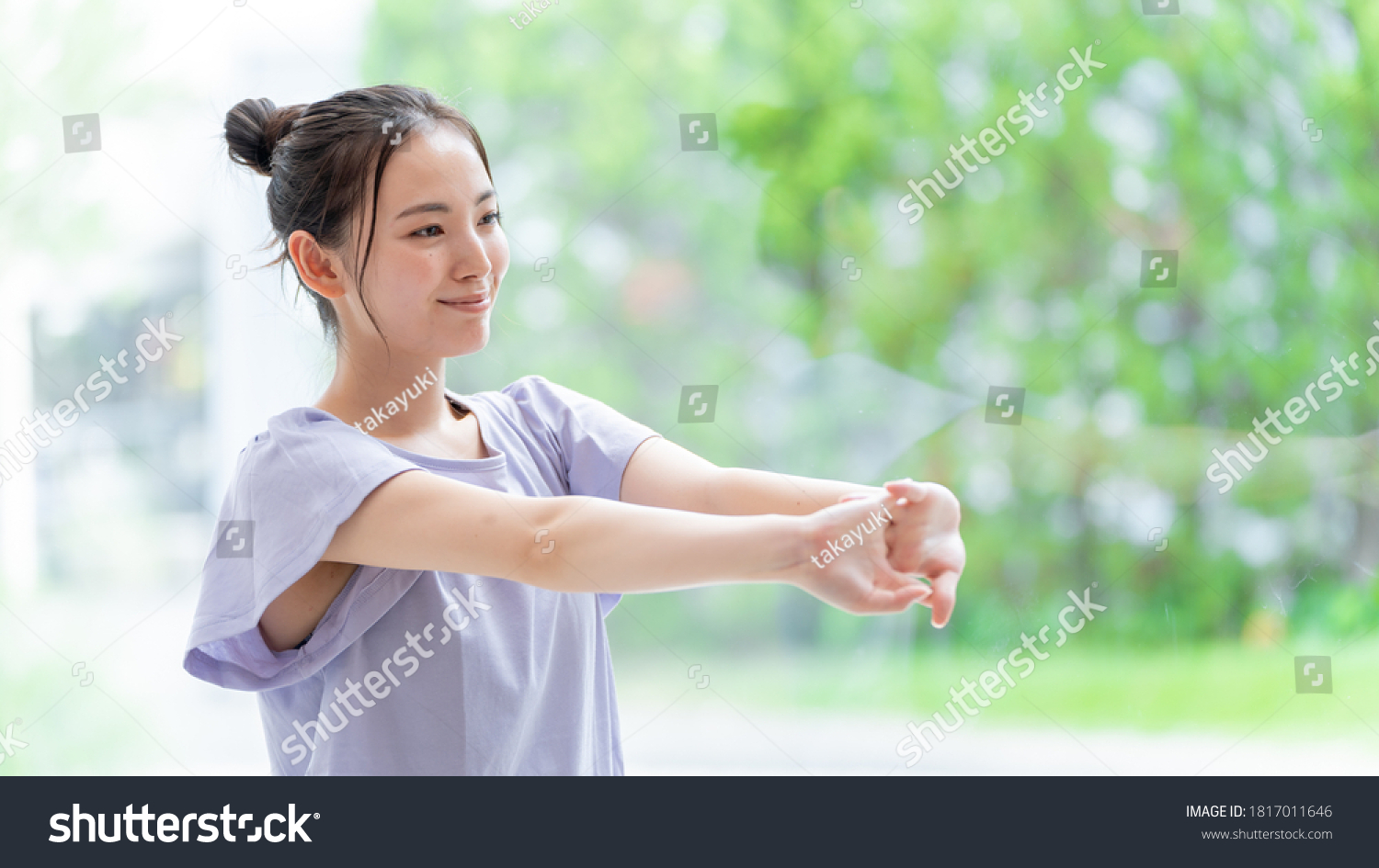 attractive asian woman stretching at living room