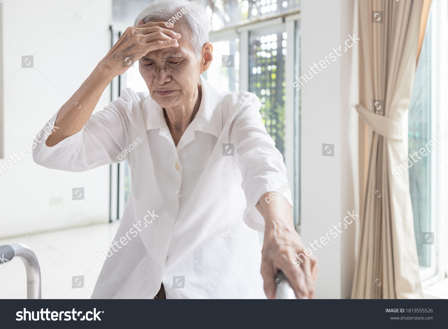 Exhausted asian senior woman is touching her head with hand symptoms of vertigo illness loss balance dizzy meniere’s disease feel unwell faint sick elderly people having a headache health problem