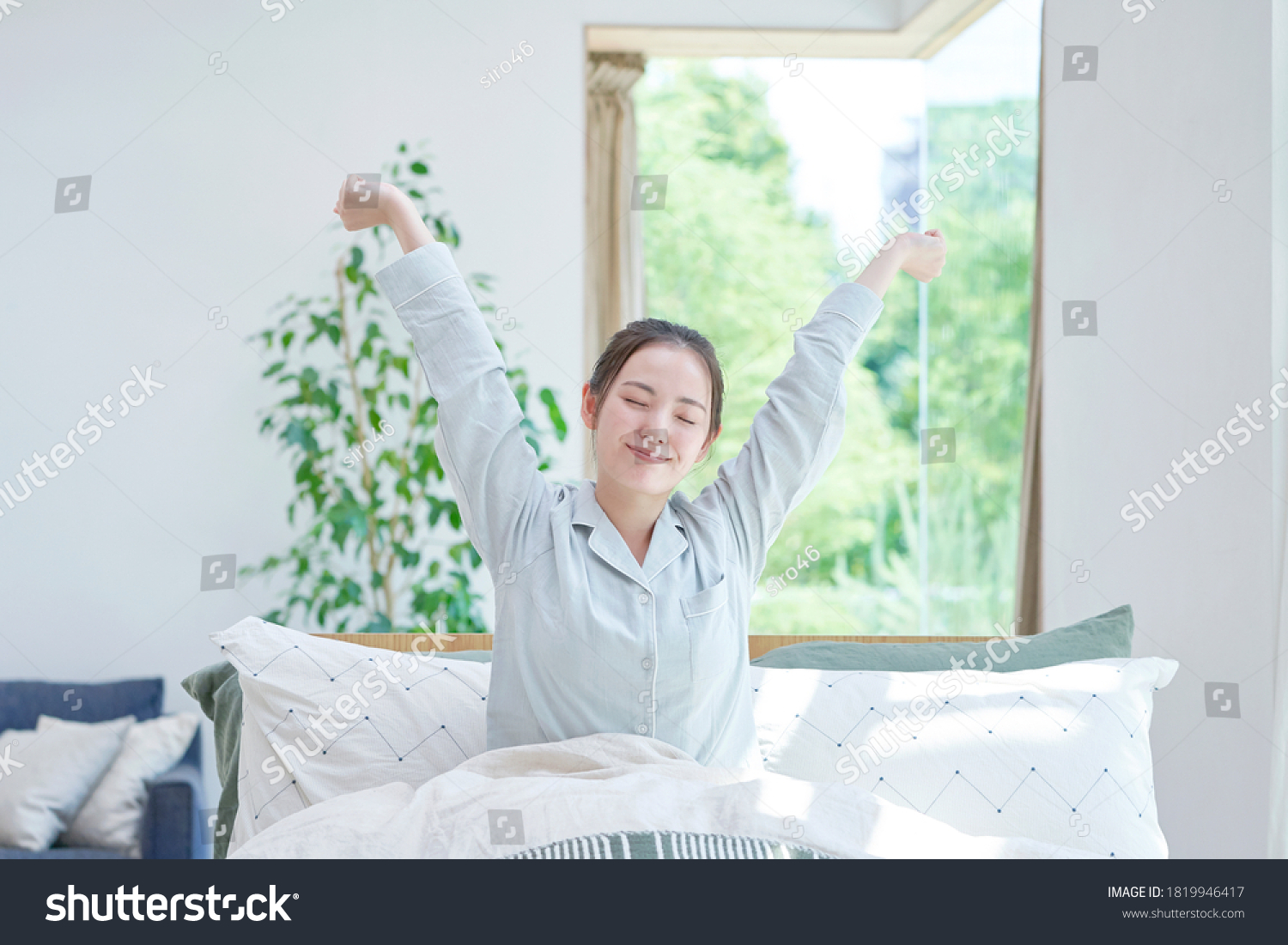 Asian woman waking up at home