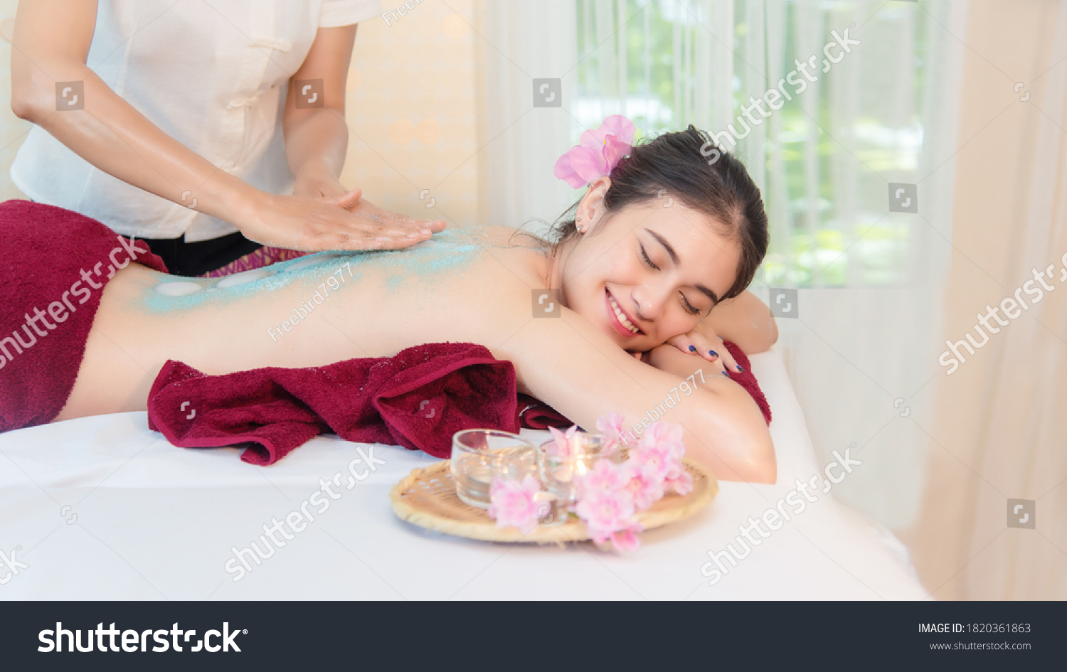 Spa Massage.  Masseur doing massage with treatment sugar scrub on Asian woman body in the Thai spa lifestyle  Young beauty people relaxation for body massage. Healthy and Lifestyle Concept