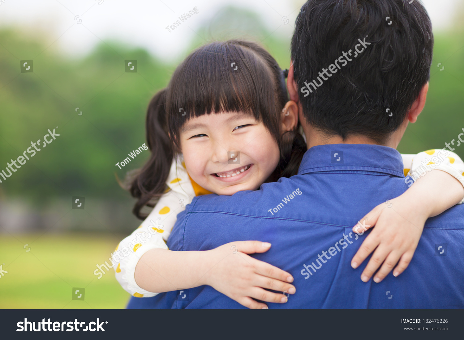 happy little girl hugging embracing her father