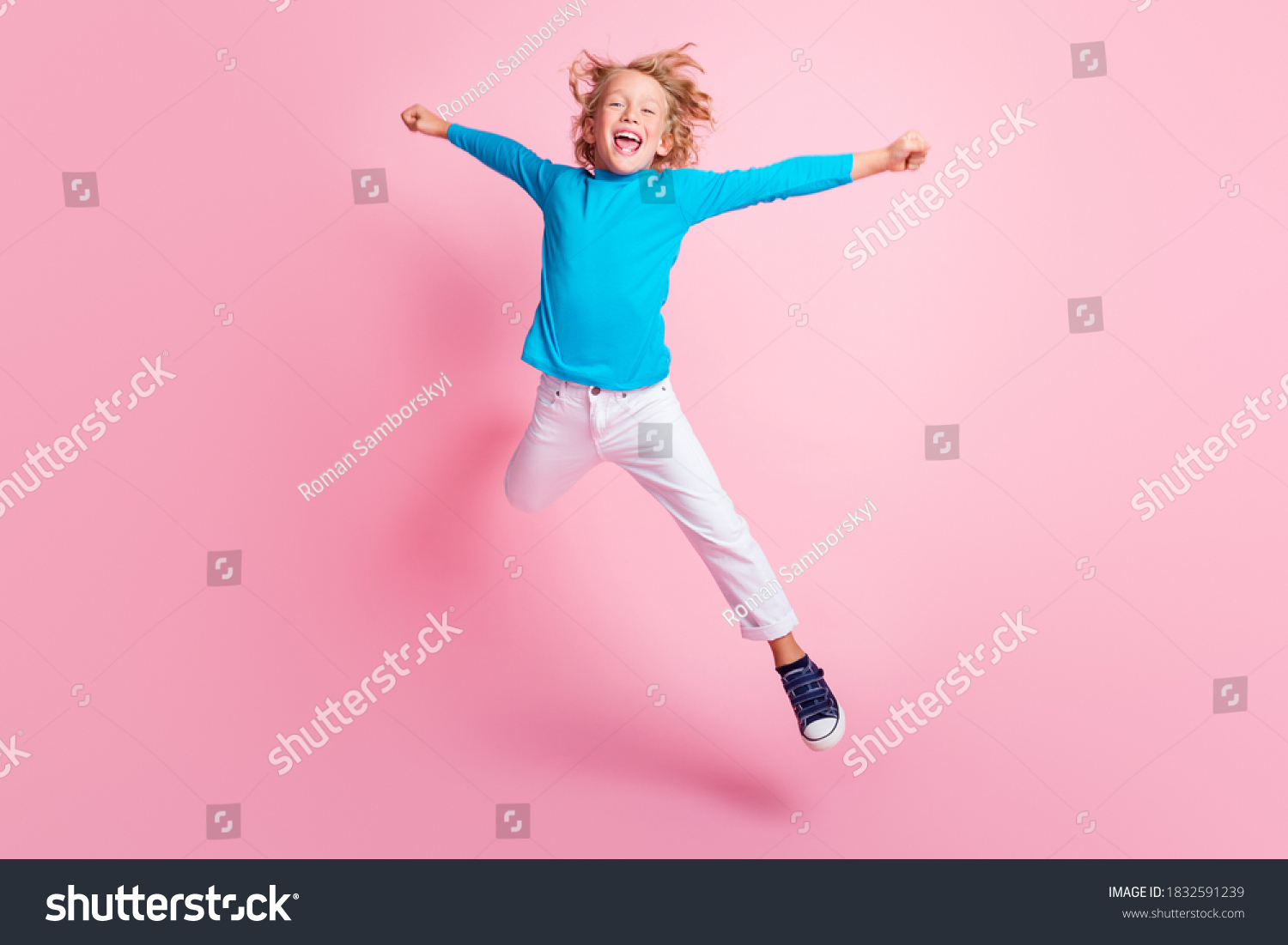 Full length photo of small boy jump star pose wear blue turtleneck pants sneakers isolated pastel pink color background