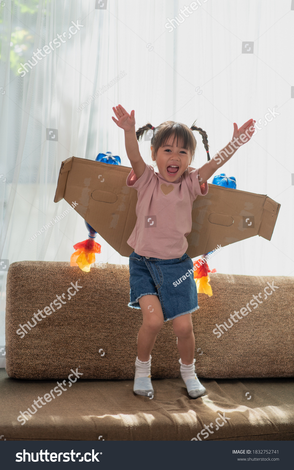 Portrait of happy Asian little child girl playing in an astronaut costume